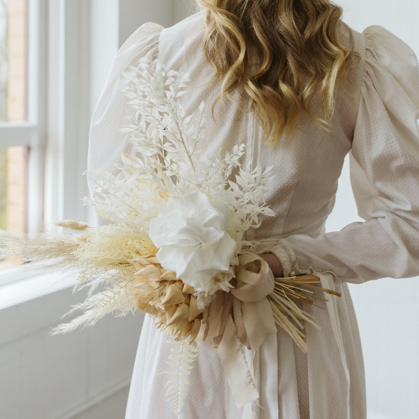 Photo is an example of a bridal bouquet with taupe accent color.