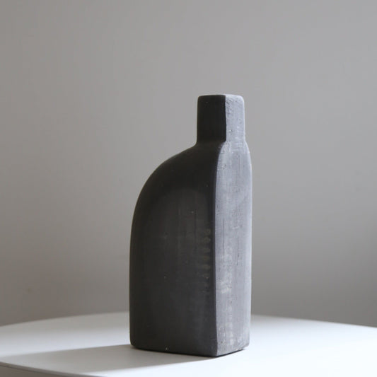 Black ceramic bud vase available at Rook & Rose.