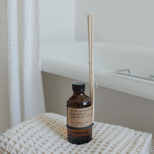 P.F. Candle Co Teakwood & Tobacco reed diffuser with rattan reeds available at Rook & Rose.