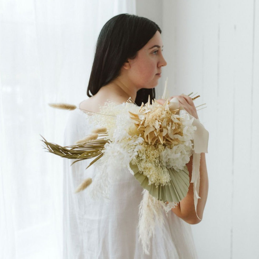 Photo is an example of a bridal bouquet with olive accent color.