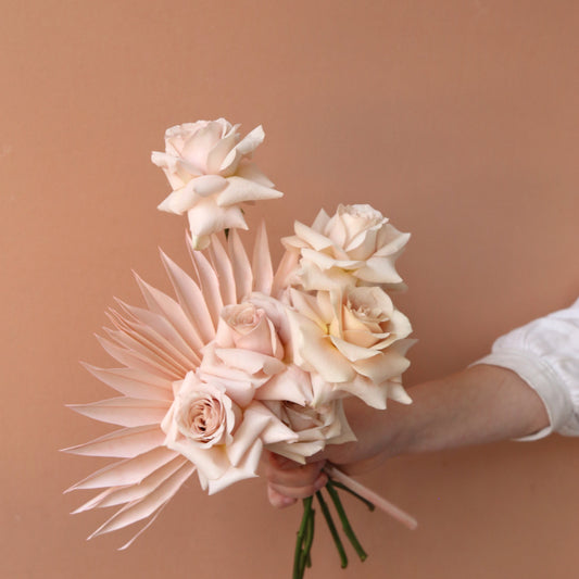Photo is an example of a mostly blush half dozen fresh rose bouquet.