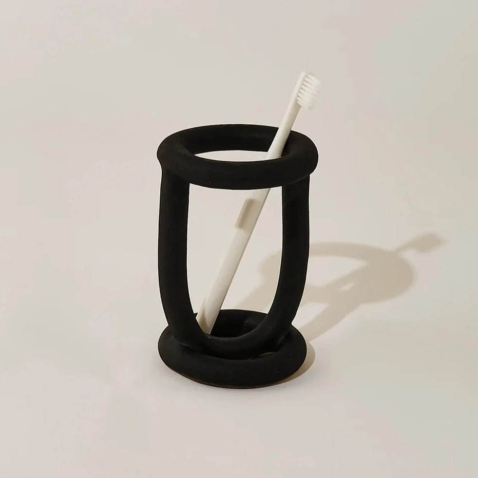SIN ceramic buoy toothbrush holder in black available at Rook & Rose.