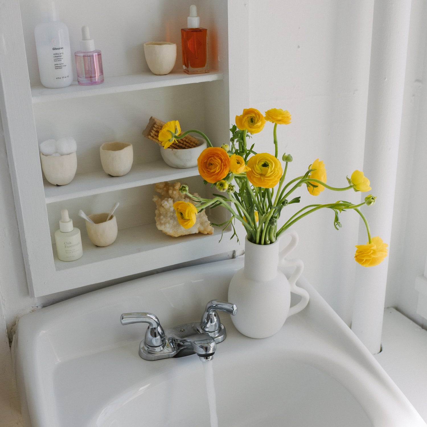 Ceramic white vase with yellow ranunculus available at Rook & Rose.